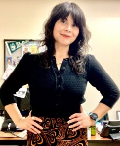 librarian in black shirt, hands on hips