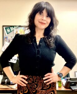 librarian in black shirt, hands on hips